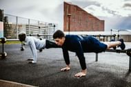 Partner workout of the day (Image via Getty Images)